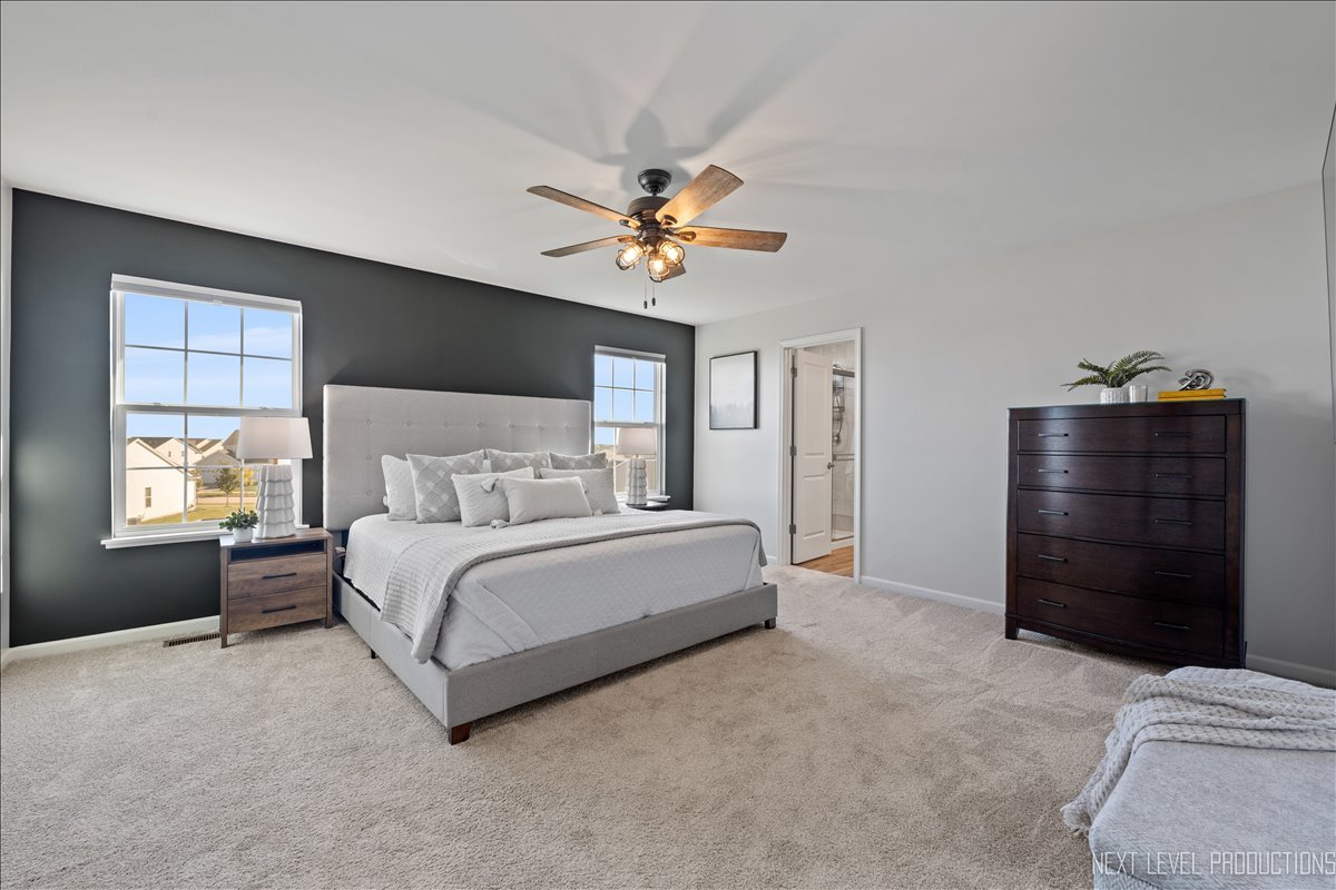 2236 Fairfax Way Yorkville, IL 60560 - Photo 17 of 28 a spacious bedroom with a bed and a chandelier