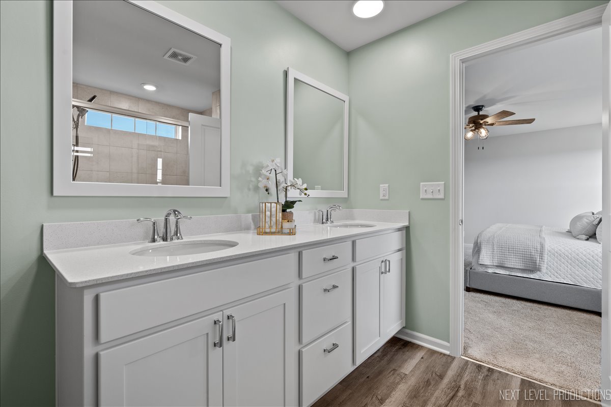 2236 Fairfax Way Yorkville, IL 60560 - Photo 19 of 28 a spacious bathroom with a double vanity sink and mirror