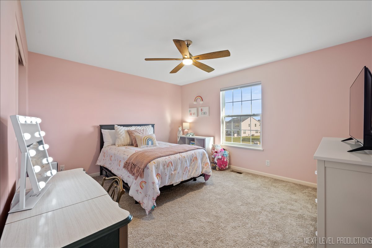 2236 Fairfax Way Yorkville, IL 60560 - Photo 21 of 28 a bedroom with bed a chandelier and a window