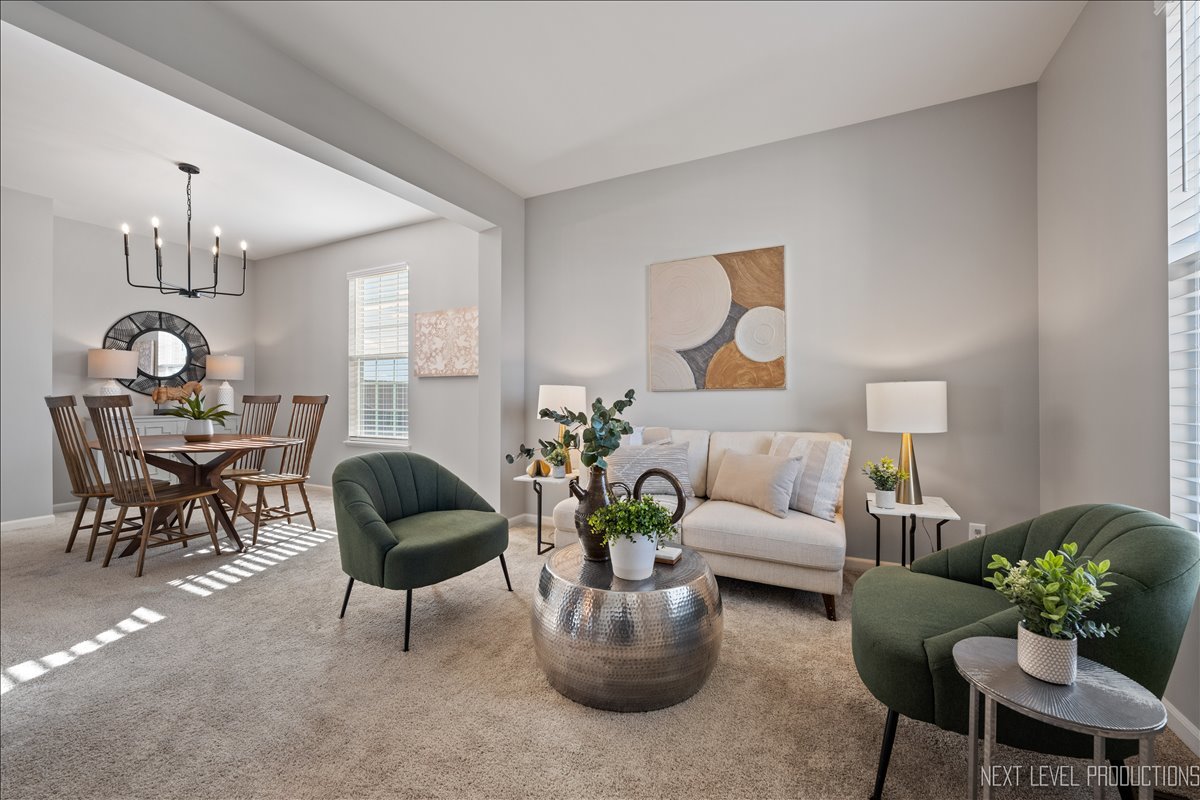 2236 Fairfax Way Yorkville, IL 60560 - Photo 4 of 28 a living room with furniture a chandelier and a potted plant