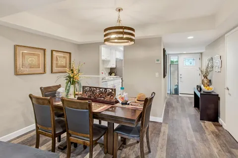 a view of a dining room with furniture and wooden floor