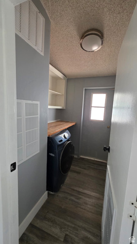 1450 North Dixie Downs Road, Unit 51 St. George, UT 84770 - Photo 25 of 25 Utility area featuring wood-finish flooring, light gray walls, built-in shelving, a wood-finish countertop, and a rear exterior door with a window