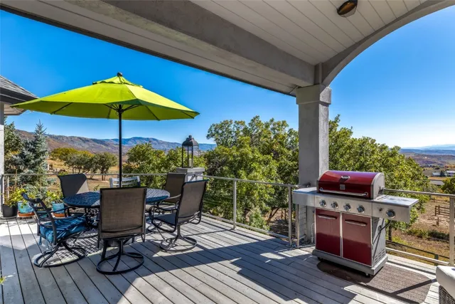 a view of a terrace with furniture and umbrella