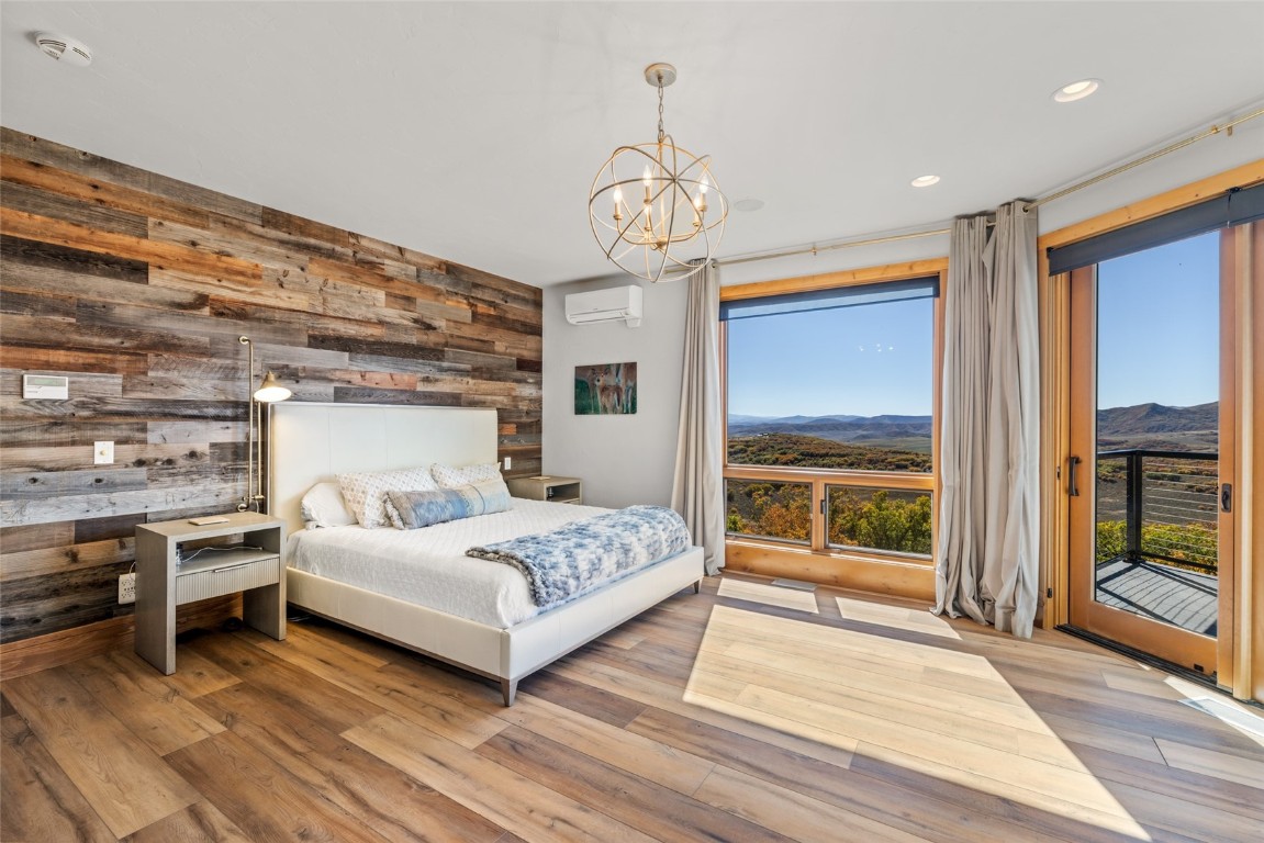 44300 Diamondback Way Steamboat Springs, CO 80487 - Photo 19 of 49 a bedroom with a bed and a large window with balcony view