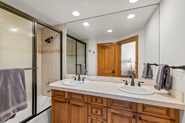 a bathroom with double vanity sink and a mirror