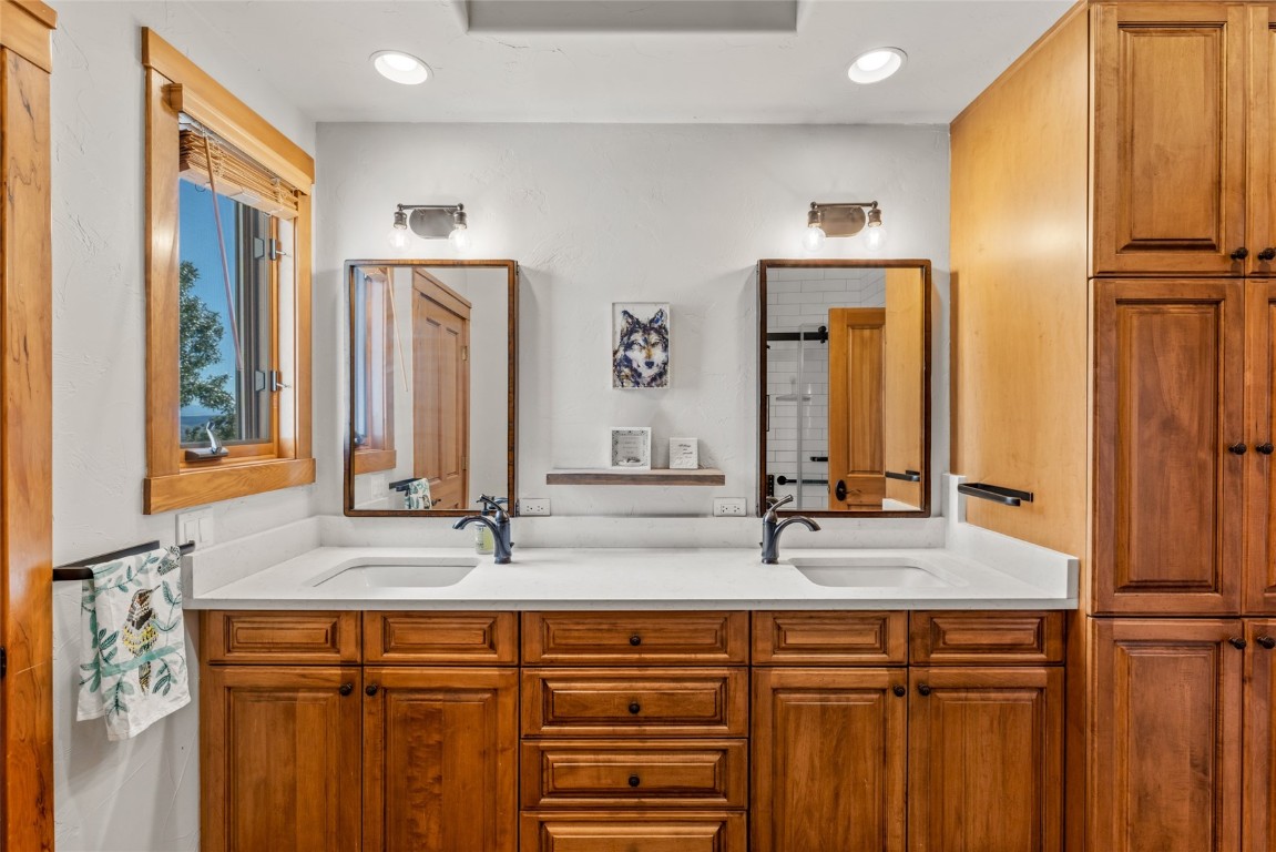 44300 Diamondback Way Steamboat Springs, CO 80487 - Photo 32 of 49 a bathroom with a double vanity sink and a mirror