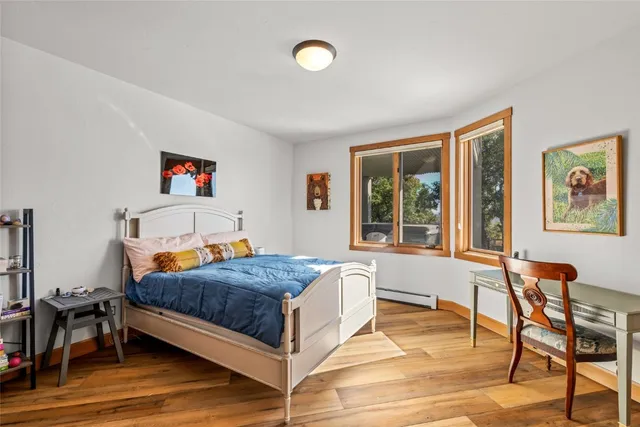 a bedroom with a bed and a table in it