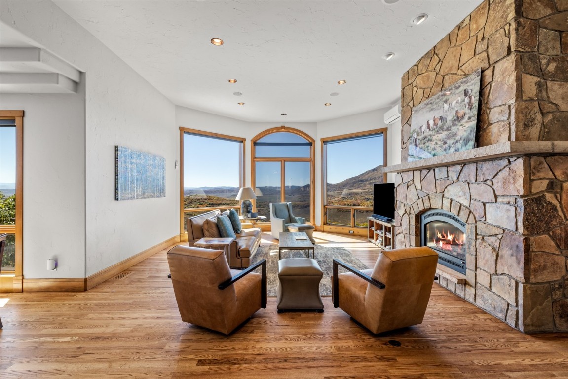 44300 Diamondback Way Steamboat Springs, CO 80487 - Photo 7 of 49 a living room with fireplace furniture and a wooden floor