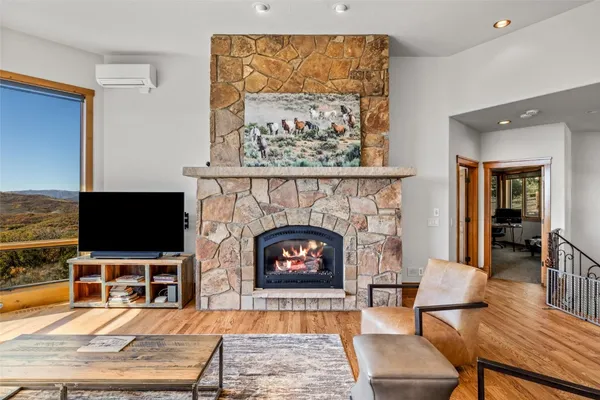 a living room with furniture a flat screen tv and a fireplace