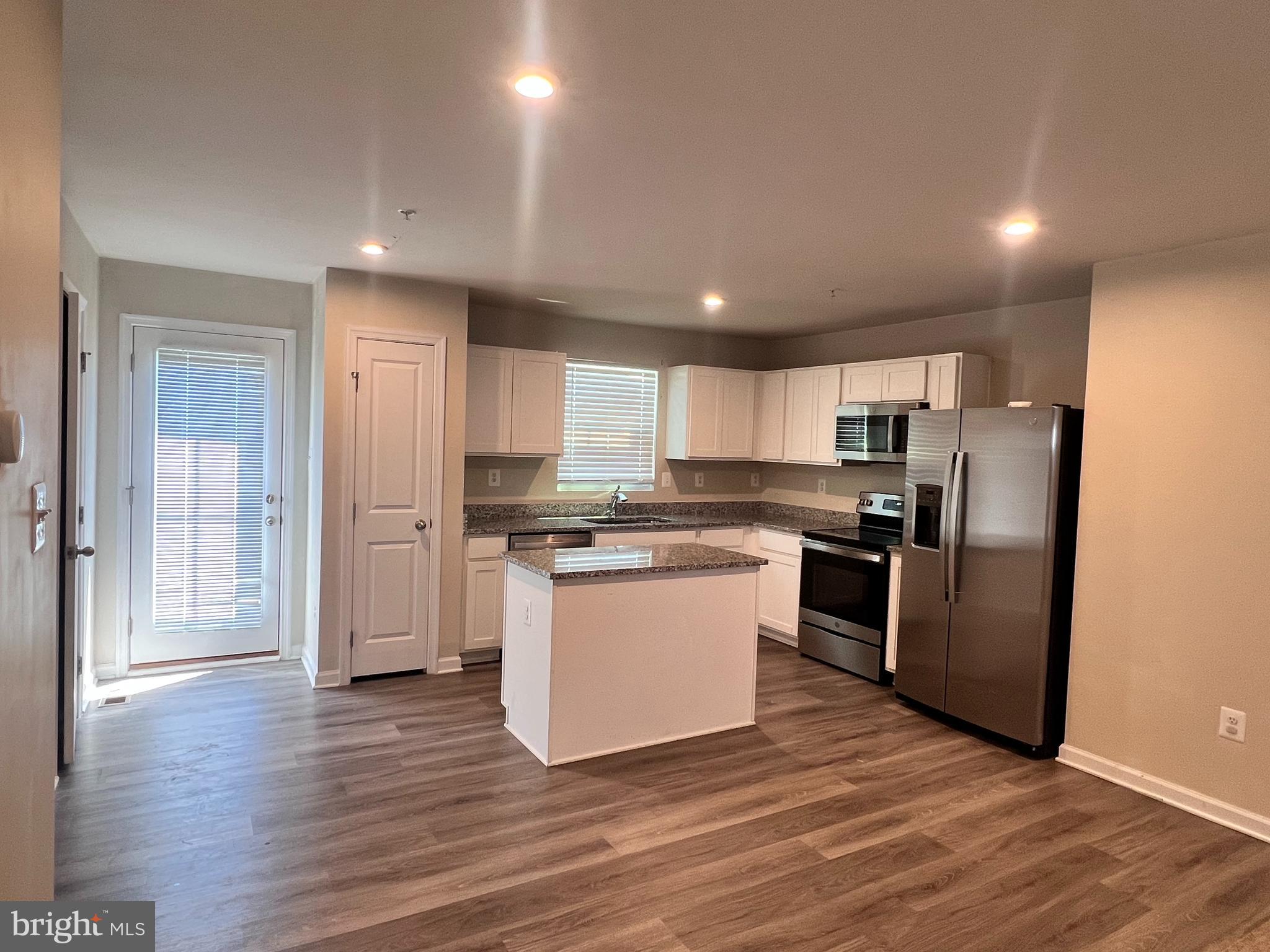 122 Butterfield Avenue Taneytown, MD 21787 - Photo 5 of 19 a kitchen with stainless steel appliances granite countertop a refrigerator and a stove top oven