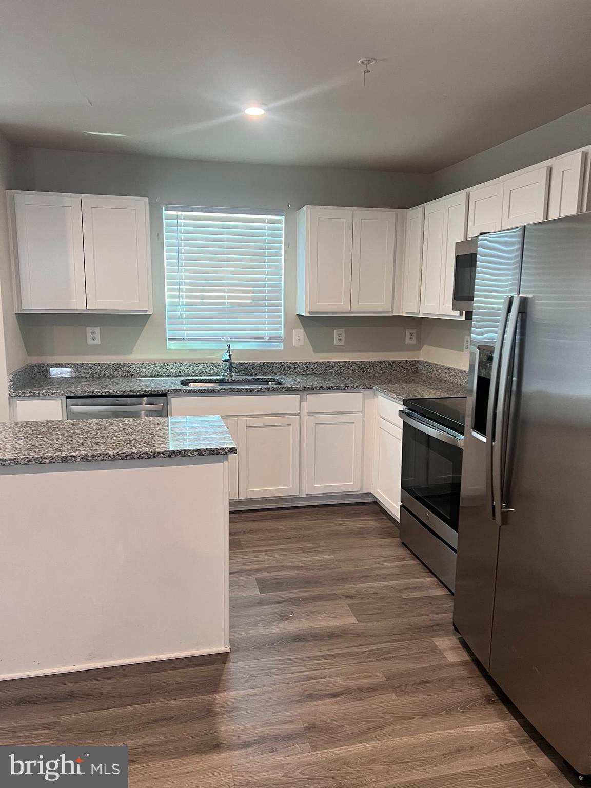122 Butterfield Avenue Taneytown, MD 21787 - Photo 6 of 19 a kitchen with stainless steel appliances granite countertop a stove a sink and a refrigerator