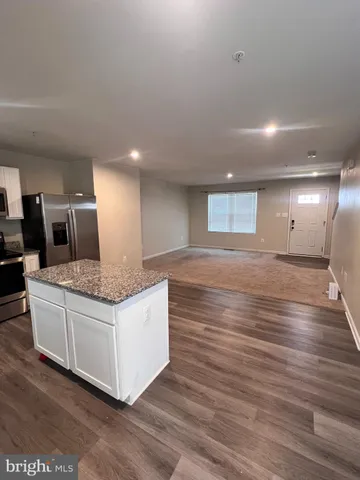a view of kitchen and hall with wooden floor