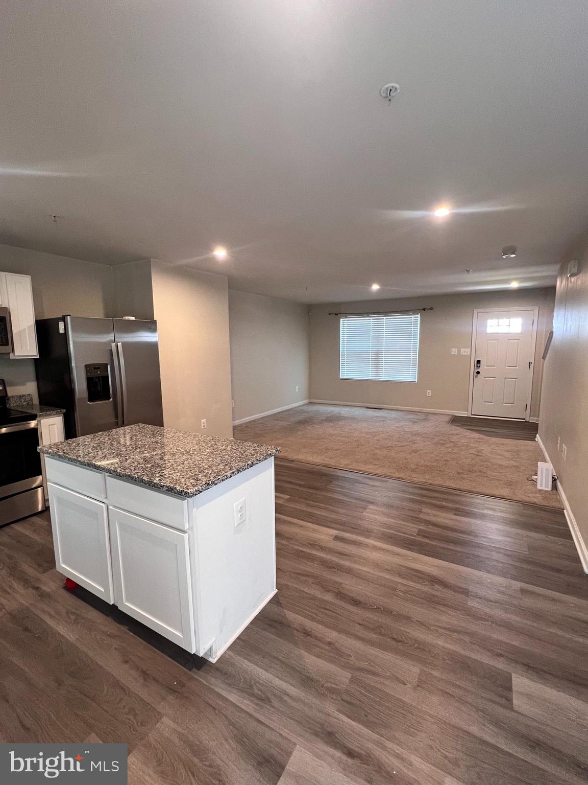 122 Butterfield Avenue Taneytown, MD 21787 - Photo 9 of 19 a view of kitchen and hall with wooden floor