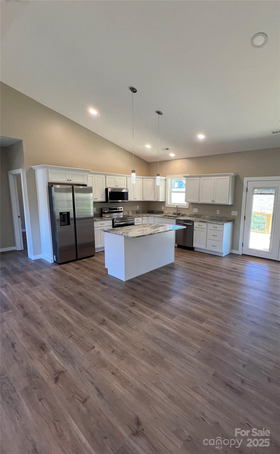 130 Peyton Elaine Road Clyde, NC 28721 - Photo 6 of 12 a kitchen with stainless steel appliances wooden floors wooden cabinets and entryway