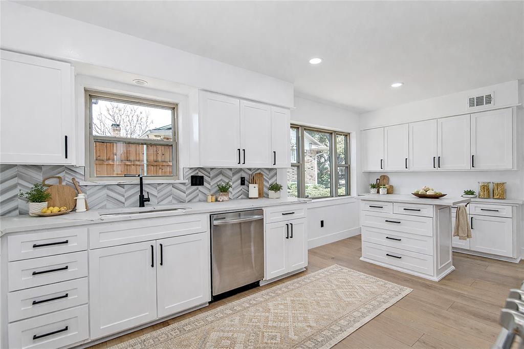 7992 Fallmeadow Lane Dallas, TX 75248 - Photo 12 of 30 a kitchen with cabinets appliances a sink and a window