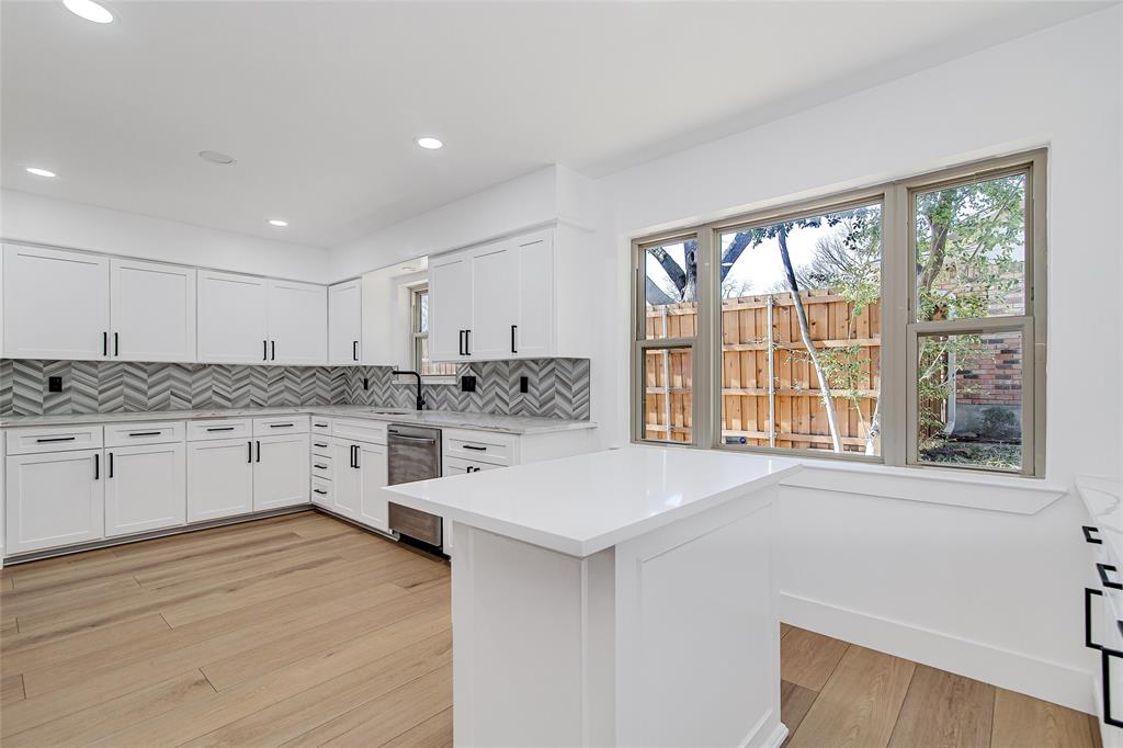 7992 Fallmeadow Lane Dallas, TX 75248 - Photo 13 of 30 a kitchen with granite countertop white cabinets and white appliances