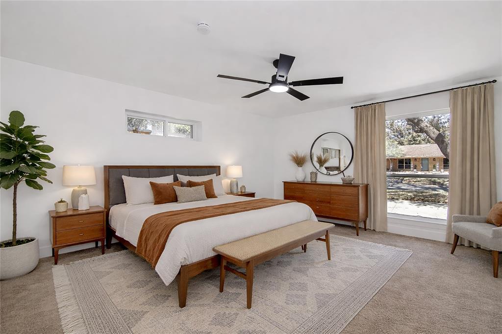 7992 Fallmeadow Lane Dallas, TX 75248 - Photo 16 of 30 a bedroom with a bed and a large window