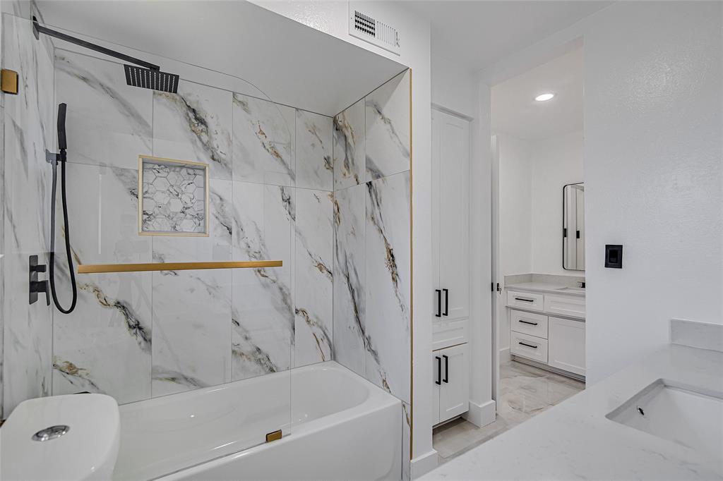 7992 Fallmeadow Lane Dallas, TX 75248 - Photo 22 of 30 a bathroom with a bathtub and a shower