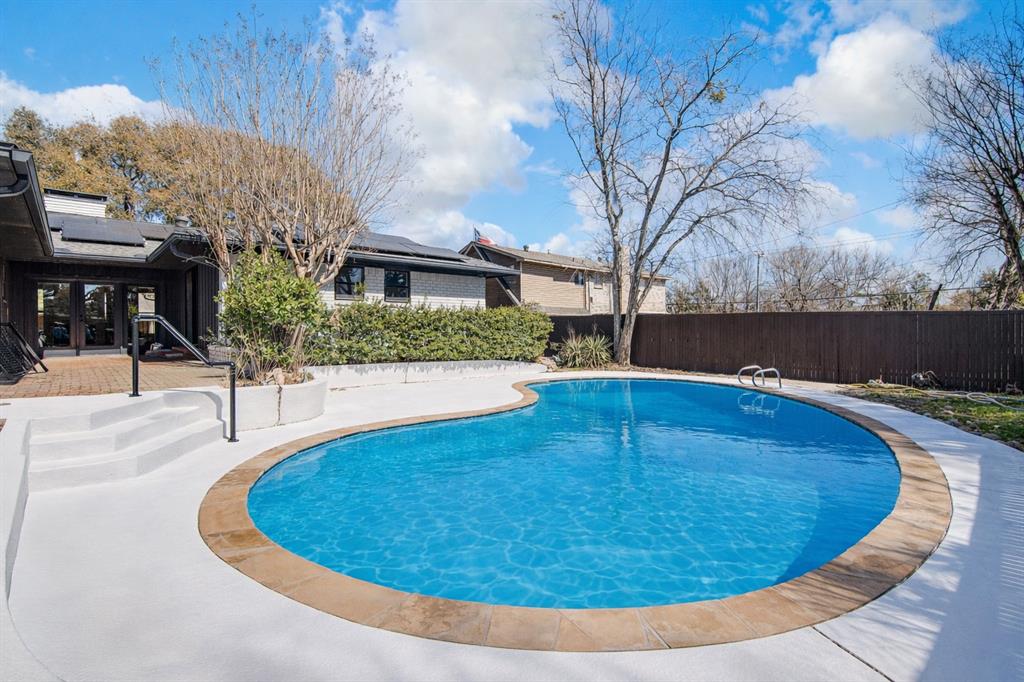 7992 Fallmeadow Lane Dallas, TX 75248 - Photo 29 of 30 a view of a swimming pool with a patio