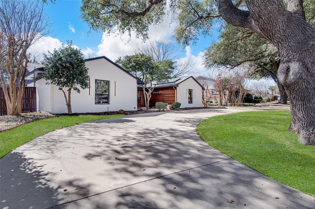 7992 Fallmeadow Lane Dallas, TX 75248 - Photo 3 of 30 a view of a white house with a big yard and large trees