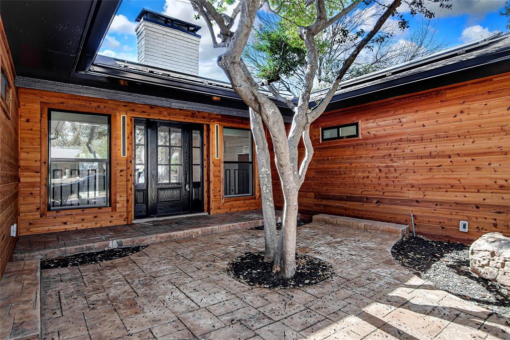 7992 Fallmeadow Lane Dallas, TX 75248 - Photo 5 of 30 a tree in front of a building