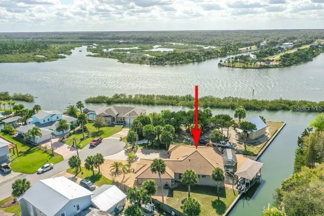 an aerial view of residential houses with outdoor space and lake view