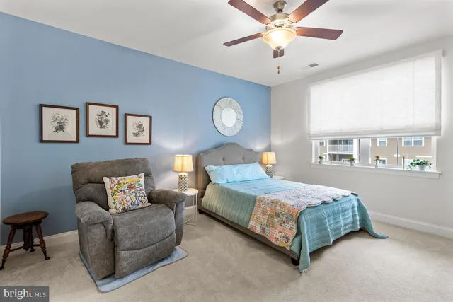 a bedroom with a bed couch and a window