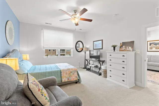 a bedroom with furniture and a large window