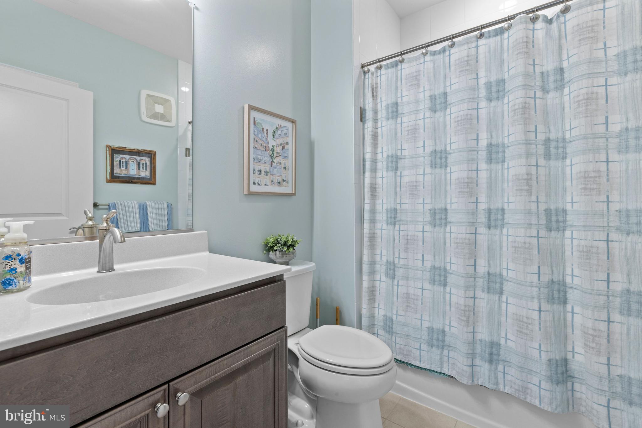 403 Bold Ruler Court, Unit 405 Havre de Grace, MD 21078 - Photo 16 of 32 a bathroom with a sink a toilet and shower curtain