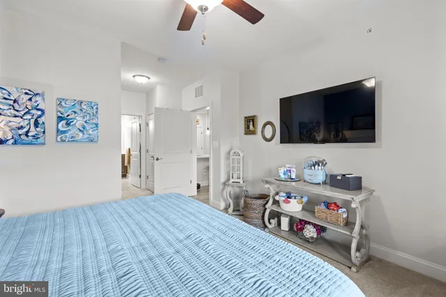 a bedroom with furniture and a flat screen tv