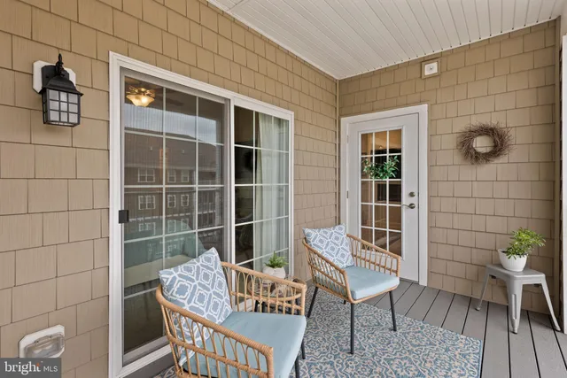 a balcony with furniture and wooden floor
