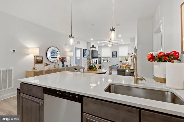 a view of a kitchen counter space a sink and living room view