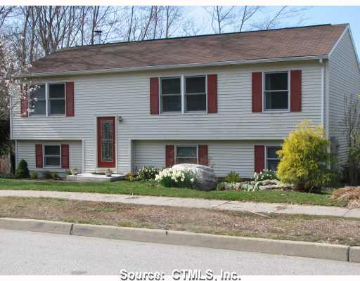 76 Deerfield Ridge Drive Groton, CT 06355 - Photo 1 of 1 a front view of a house with a garden