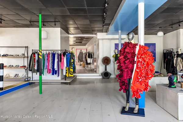 a view of outdoor space with seating and white wall