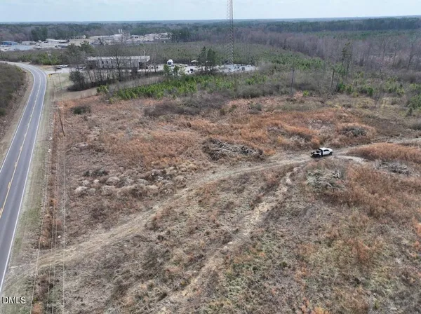 a view of a dry yard with trees