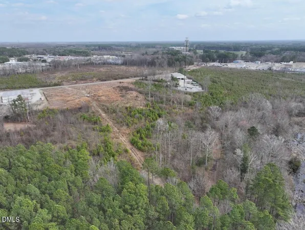 an aerial view of field with trees