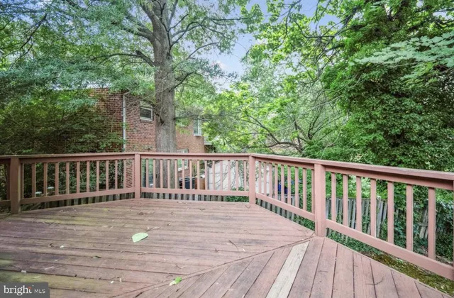 a view of balcony with wooden floor and fence
