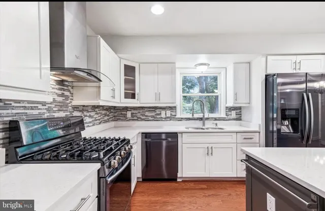 a kitchen with a stove a sink and a refrigerator