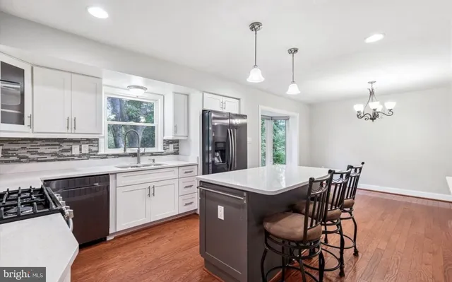 a large kitchen with a table and chairs in it