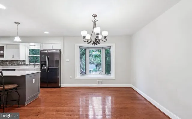a view of a kitchen with a stove cabinets and a chandelier
