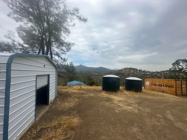 a view of a house with a white fence