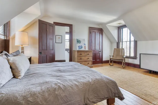 a bed room with a bed and a chair