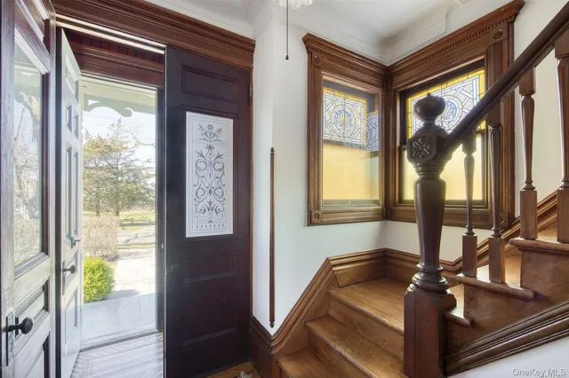 a view of living room with a large window and wooden floor