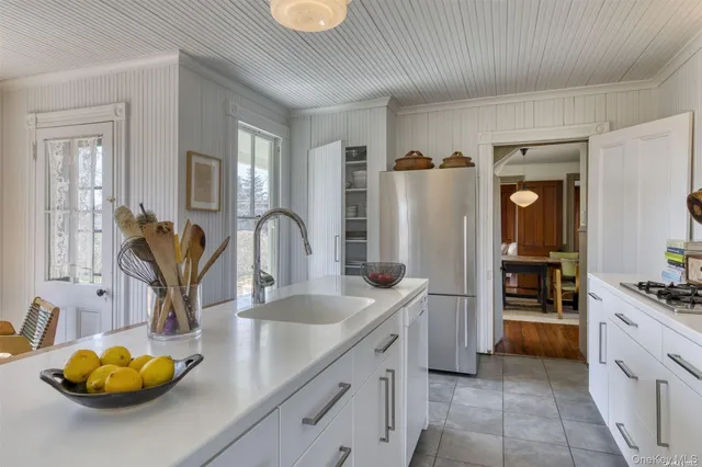 a kitchen with refrigerator and cabinets