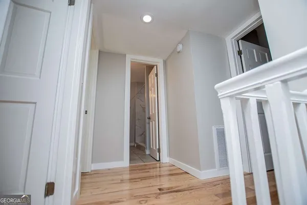 a view of a big room with wooden floor and a ceiling fan