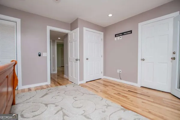 a view of a room with wooden floor and a ceiling fan