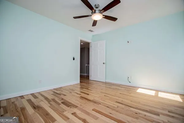 a view of room with gym equipment and a window