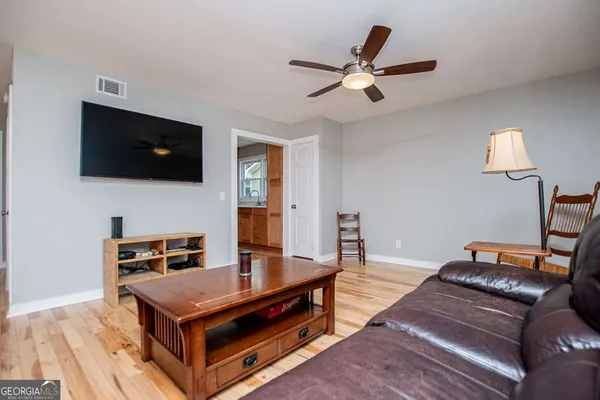 a kitchen with stainless steel appliances granite countertop a refrigerator a stove and a wooden floors