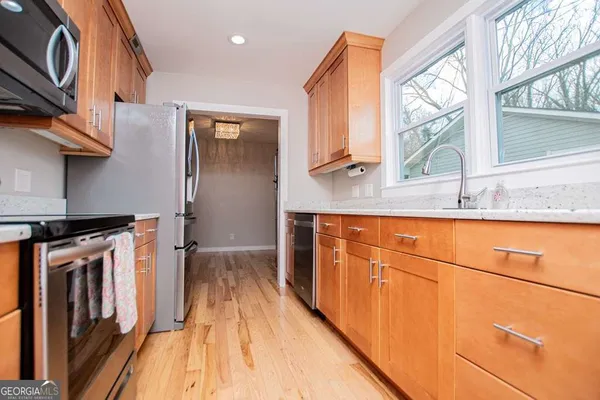 a kitchen with stainless steel appliances a stove a microwave and cabinets