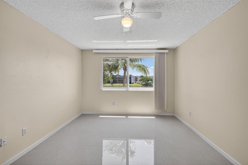 7214 South Devon Drive, Unit 7214 Tamarac, FL 33321 - Photo 11 of 24 an empty room with windows and closet